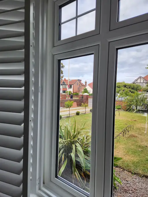 White replacement windows with interior shutters